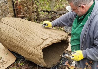 Steve begins the carving process to make this log look like a natural part of the park.